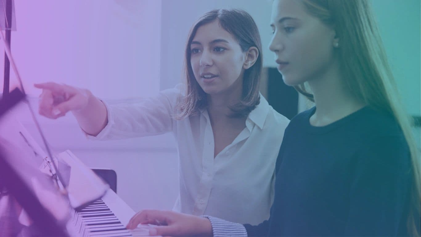 Voice student and instructor working together at a piano
